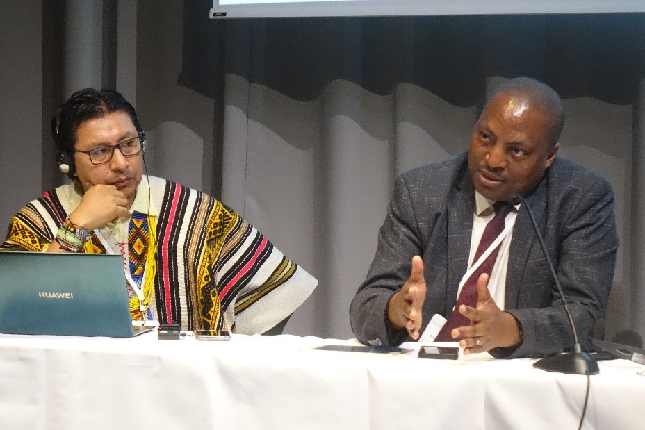 During a REDD+ Knowledge Day session on AFOLU, Pablo Jamioy, Advisor for the National Organization of Indigenous People of Colombian Amazon (left) and Bob Kazungu, Agriculture Assistant Commissioner for Forestry for Uganda’s Ministry of Water and Environment (right) share their countries’ insights. (Credit: Jillian Di Persio/World Bank)